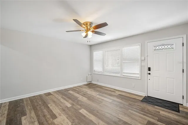 wooden floor in an empty room with a window