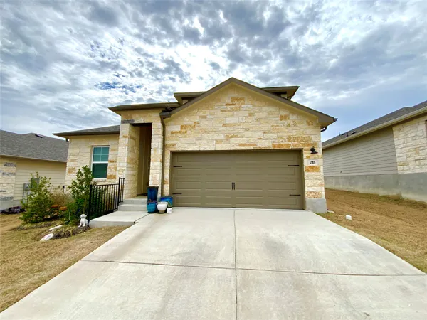 a view of a house with a yard and garage