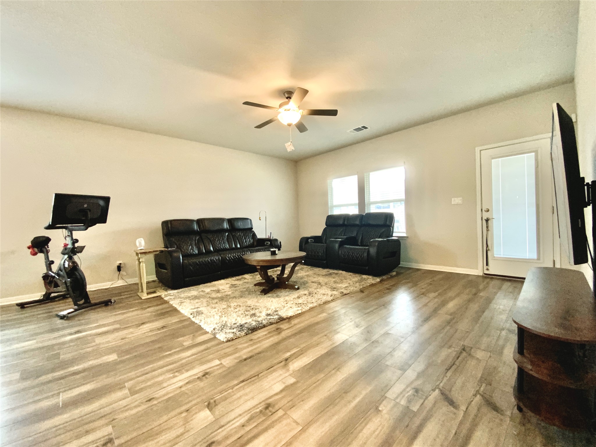 246 El Capitan Loop Dripping Springs, TX 78620 - Photo 16 of 37 Living area featuring wood finished floors and ceiling fan