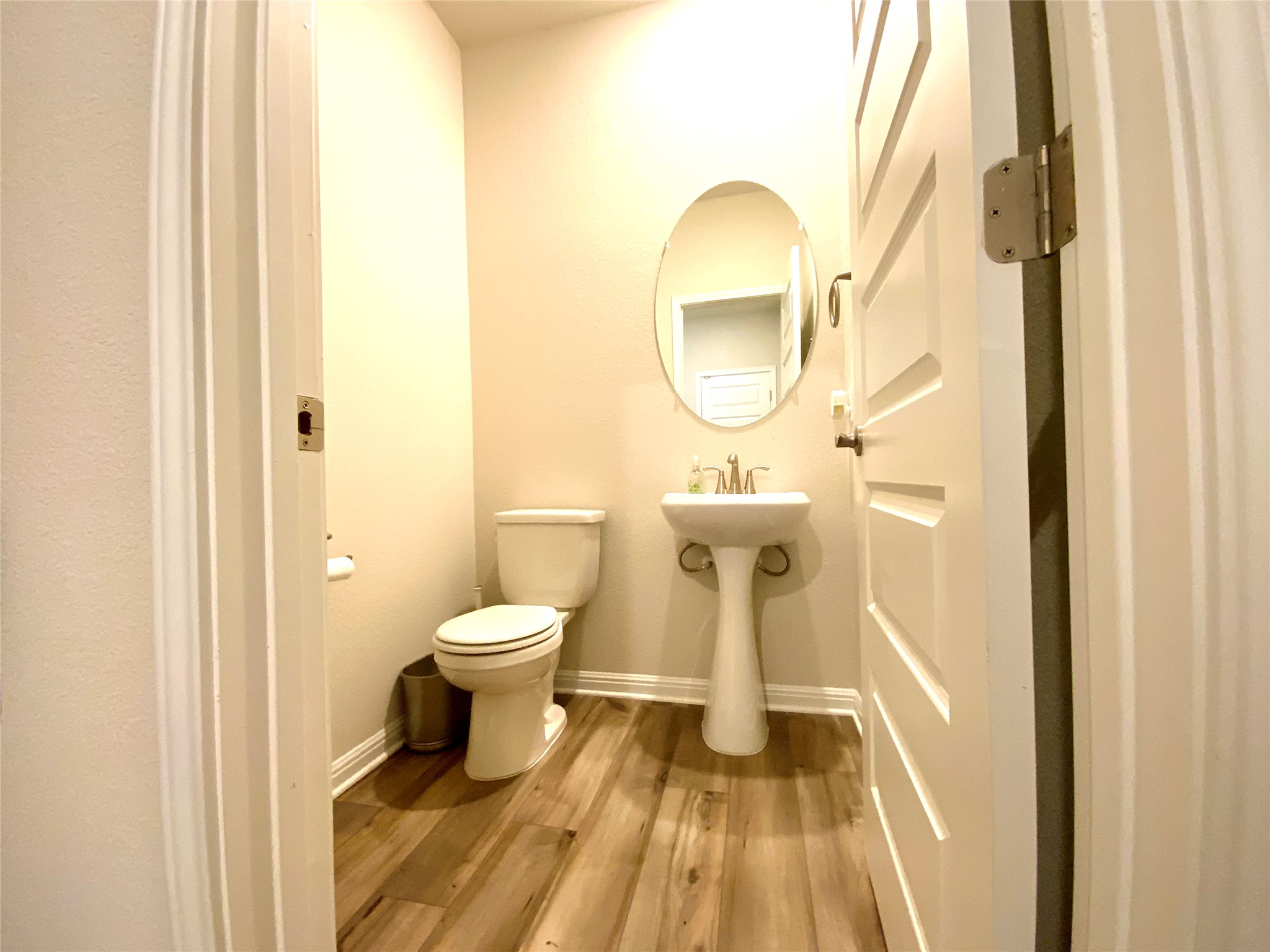 246 El Capitan Loop Dripping Springs, TX 78620 - Photo 31 of 37 Half bath featuring light wood-style floors and toilet