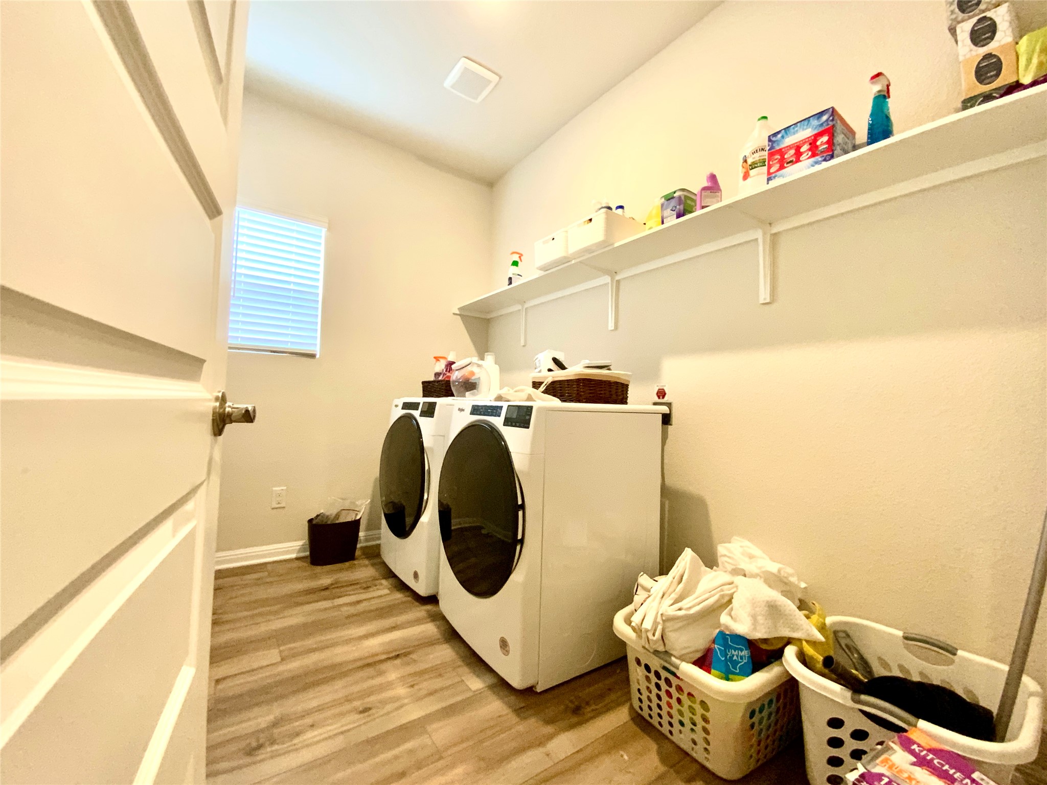 246 El Capitan Loop Dripping Springs, TX 78620 - Photo 32 of 37 Laundry room with light wood-style flooring and washer and clothes dryer