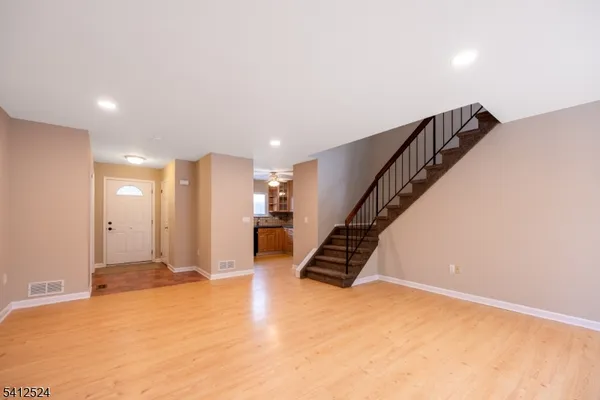 a view of an empty room with stairs