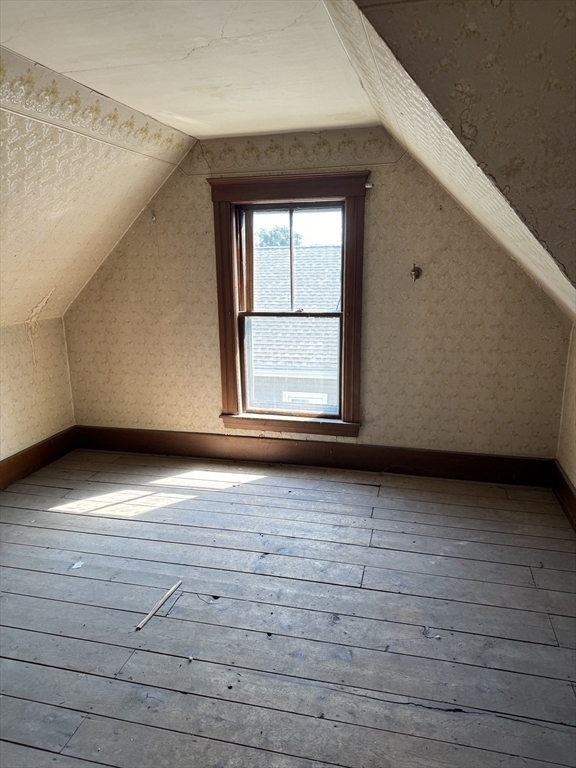 8 Eureka Street Worcester, MA 01603 - Photo 17 of 25 a view of an empty room with wooden floor and window