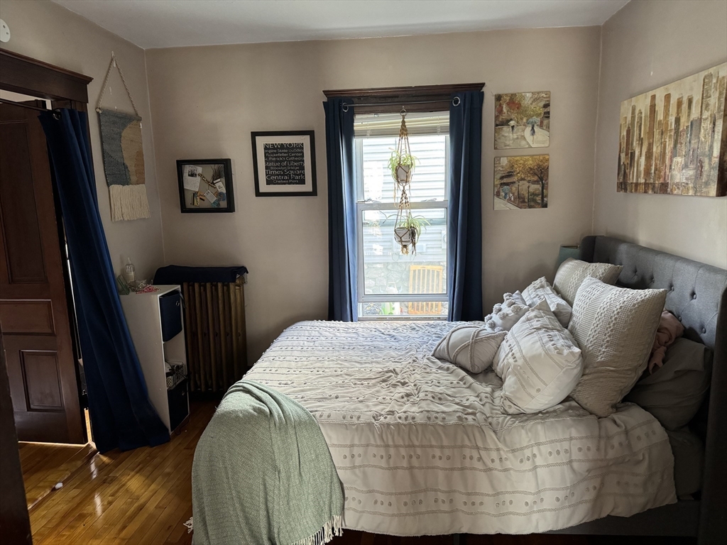 8 Eureka Street Worcester, MA 01603 - Photo 10 of 25 a bedroom with a bed a window and dresser