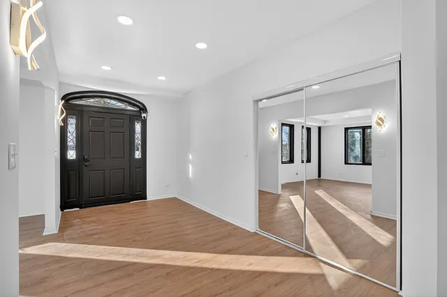 a view of an empty room with glass door and a window