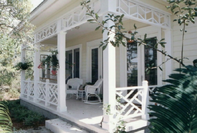 a view of a house with a potted plant and floor to ceiling windows