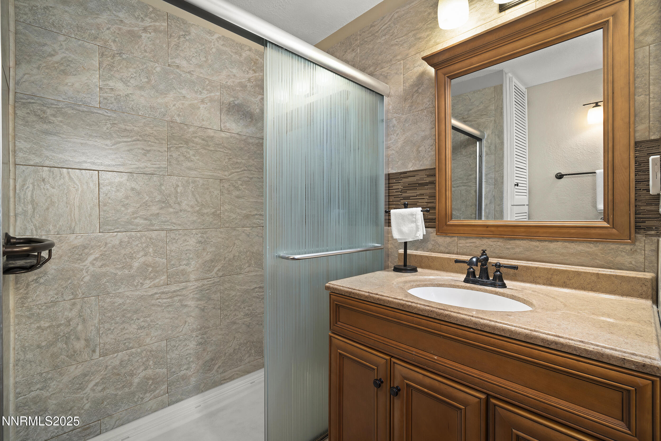 2195 West Plumb Lane Reno, NV 89509 - Photo 16 of 27 a bathroom with a sink and a mirror