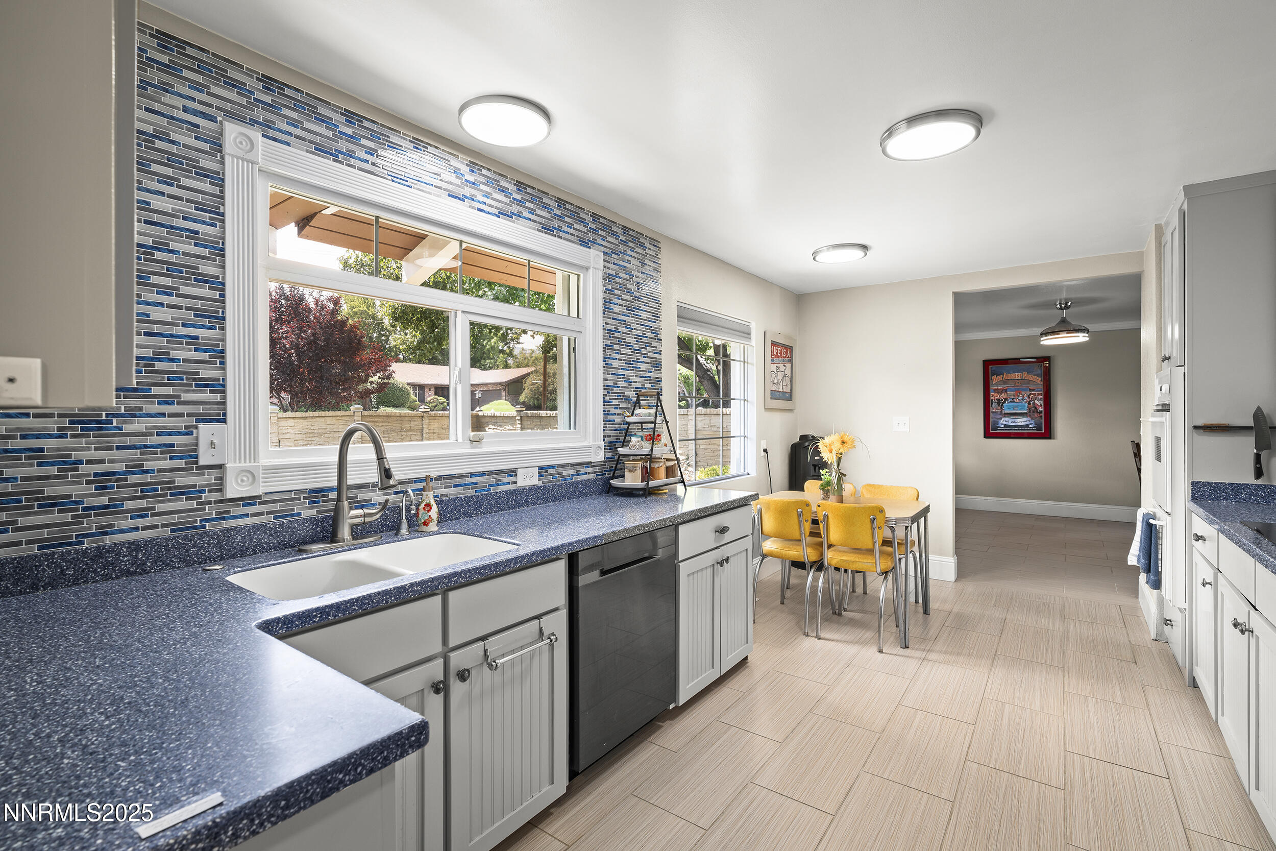 2195 West Plumb Lane Reno, NV 89509 - Photo 3 of 27 a kitchen with stainless steel appliances granite countertop sink stove and wooden cabinets