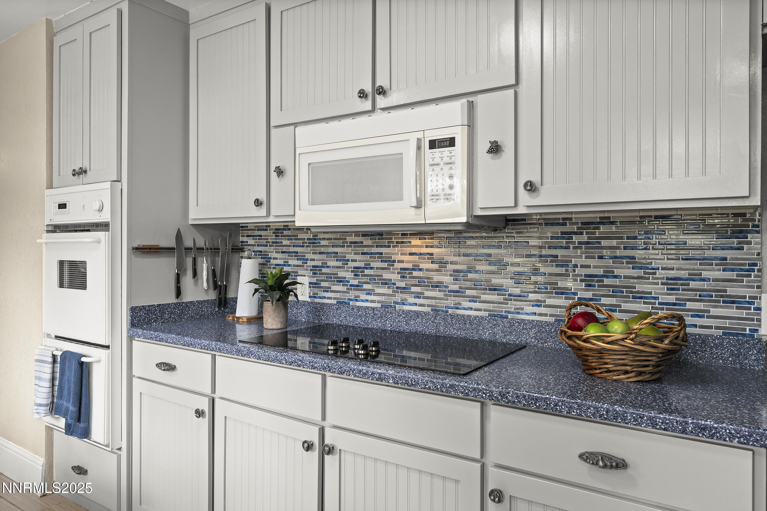 2195 West Plumb Lane Reno, NV 89509 - Photo 4 of 27 a kitchen with stainless steel appliances granite countertop a sink a stove and white cabinets