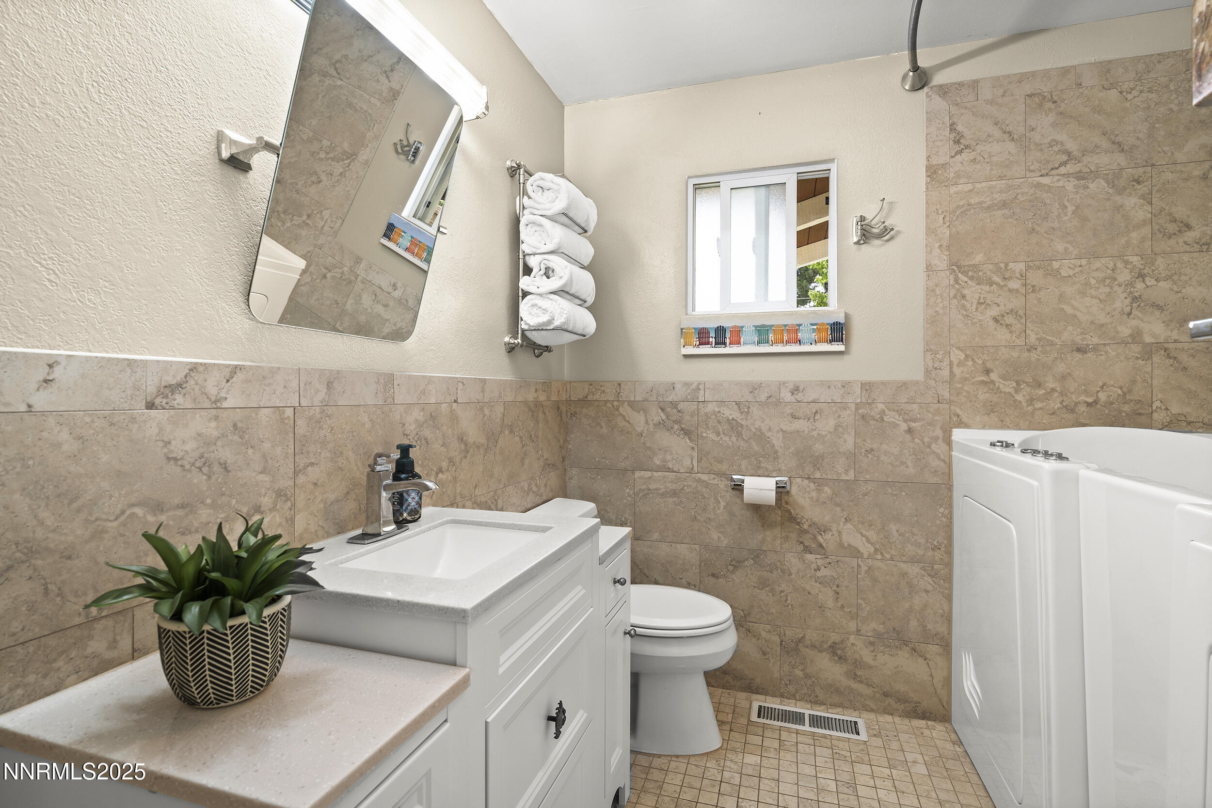 2195 West Plumb Lane Reno, NV 89509 - Photo 7 of 27 a white toilet sitting next to a bathroom sink