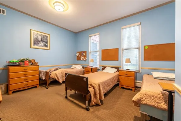 a bedroom with bed and a window