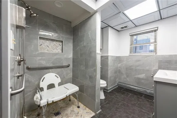 a bathroom with a toilet and a shower