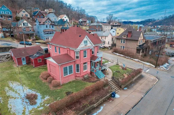 an aerial view of residential houses with outdoor space