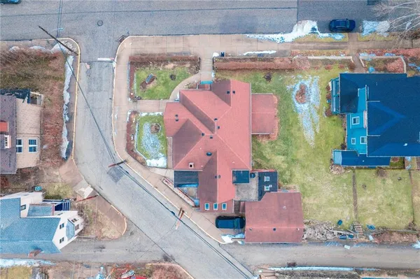 an aerial view of a house with a swimming pool