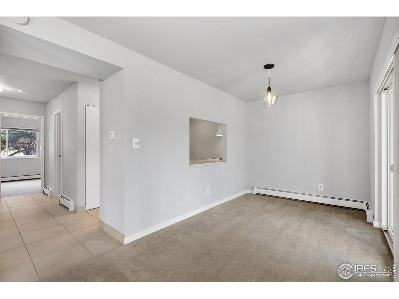 801 East Drake Road, Unit 61 Fort Collins, CO 80525 - Photo 7 of 23 an empty room with wooden floor and mirror