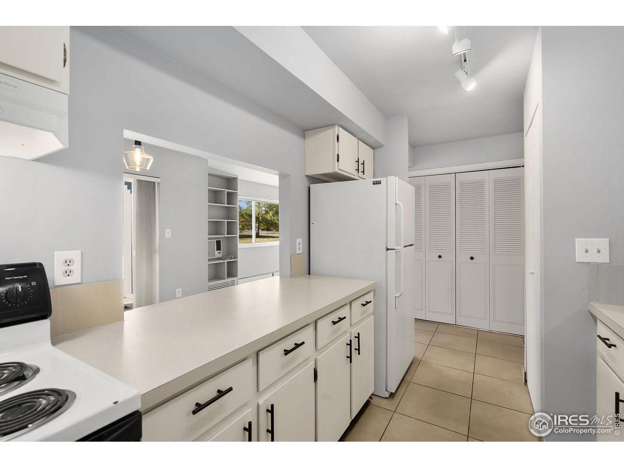 801 East Drake Road, Unit 61 Fort Collins, CO 80525 - Photo 9 of 23 a kitchen with cabinets and wooden floor