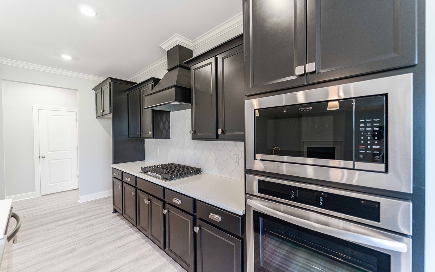 7910 Pine Street Fairview, TN 37062 - Photo 11 of 32 a kitchen with stainless steel appliances kitchen island granite countertop a stove and a microwave