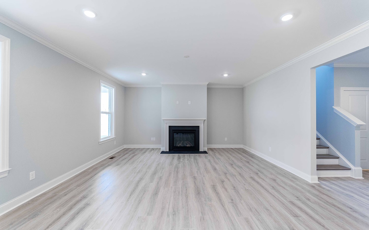 7910 Pine Street Fairview, TN 37062 - Photo 15 of 32 a view of an empty room with wooden floor fireplace and a window