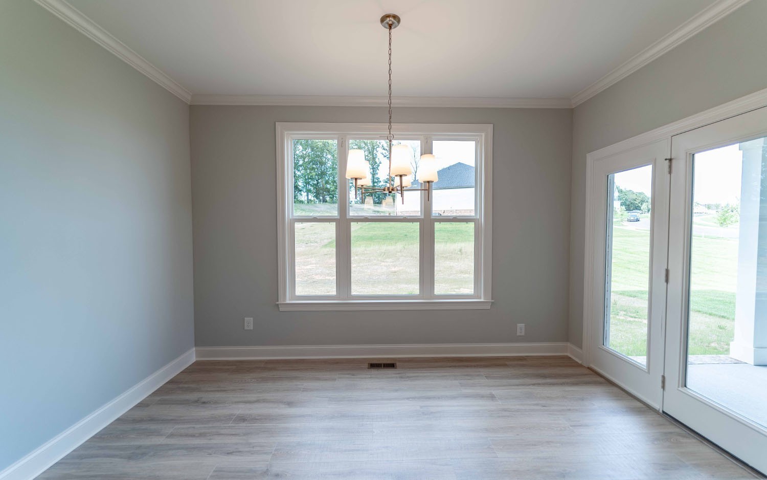 7910 Pine Street Fairview, TN 37062 - Photo 17 of 32 a view of an empty room with wooden floor and a window