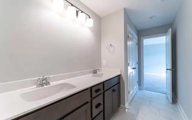 a bathroom with a double vanity sink and a mirror