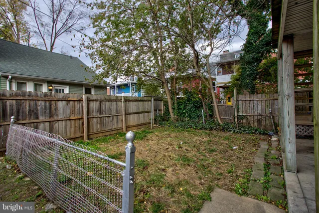 a view of house with wooden fence