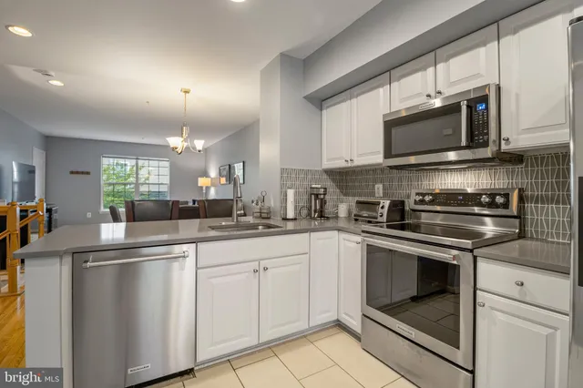 a kitchen with stainless steel appliances granite countertop a sink and a stove