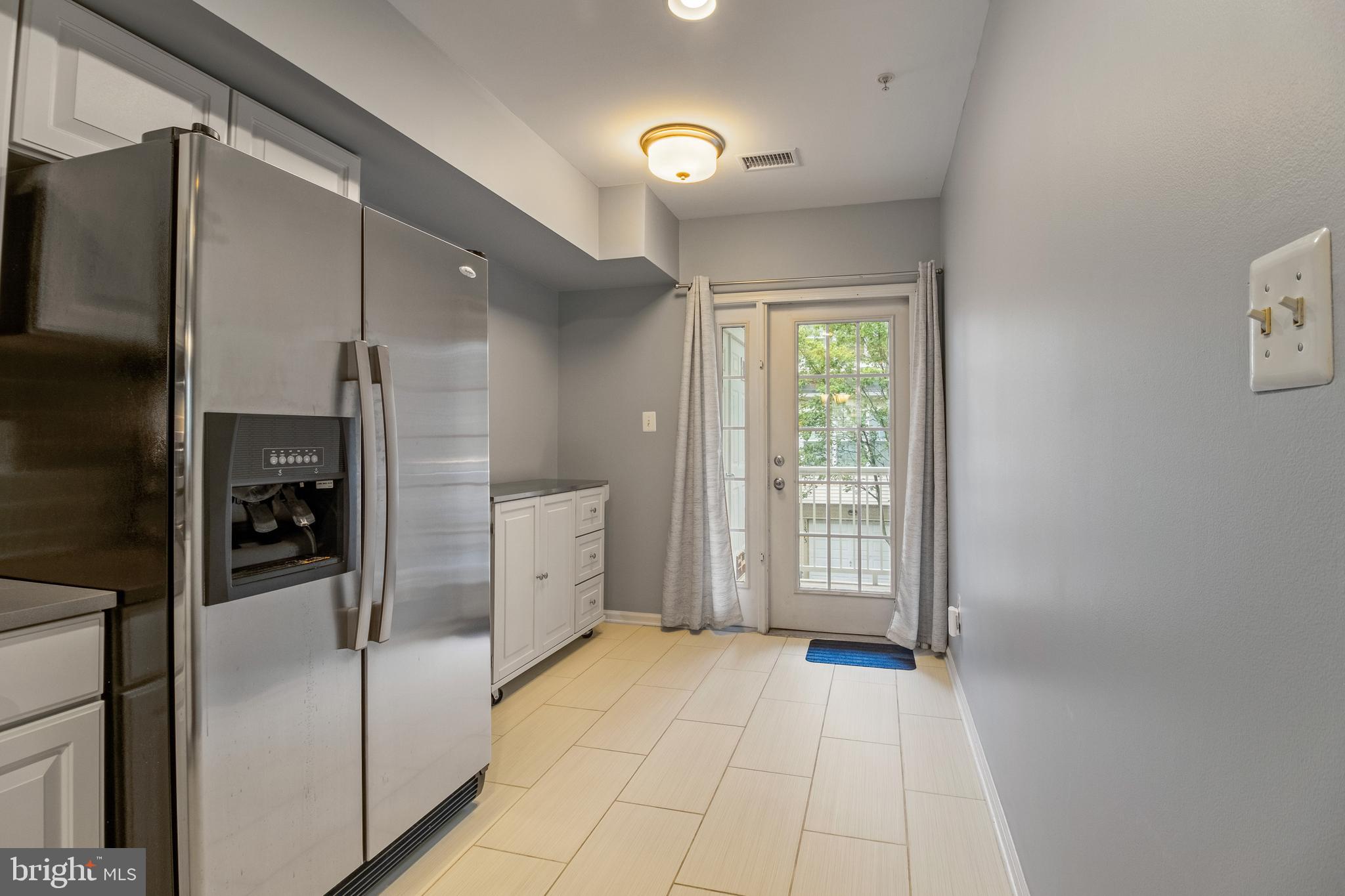11349 King George Drive, Unit 10 Silver Spring, MD 20902 - Photo 12 of 33 a view of a kitchen with a refrigerator