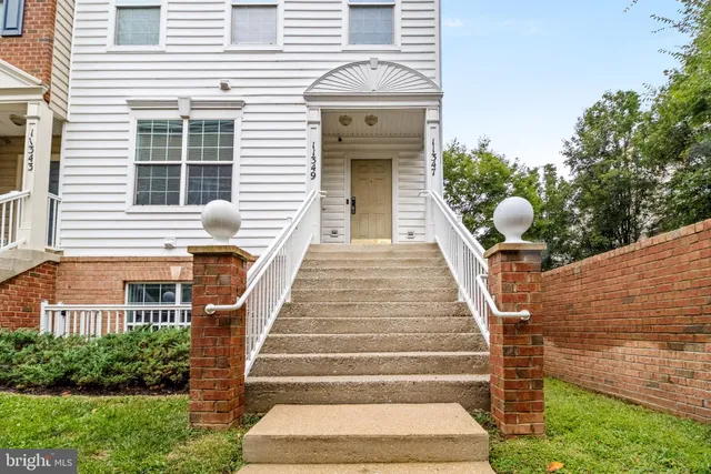 a front view of a house with a yard and a large window