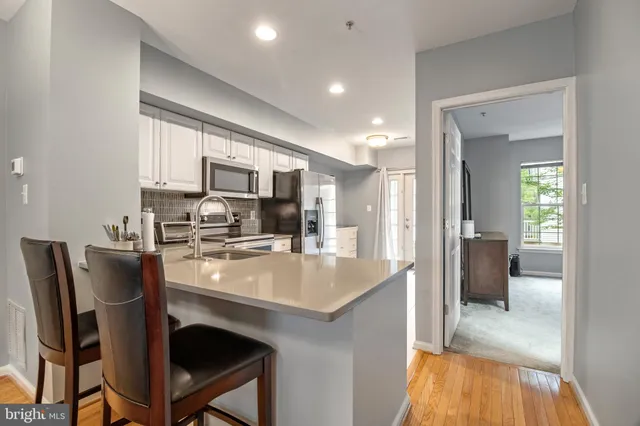 a kitchen with counter top space cabinets and stainless steel appliances