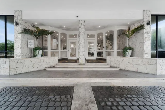a living room with fireplace furniture and a chandelier