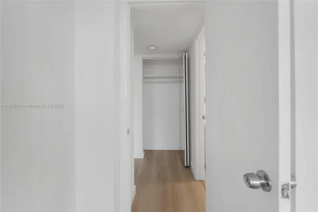 a view of a balcony with wooden floor and fence