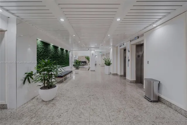 a view of hallway with closet and wooden floor