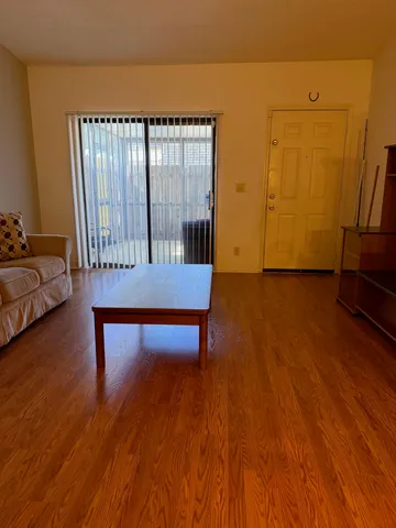 a bedroom with furniture and wooden floor