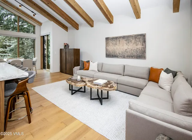 a living room with furniture and large window