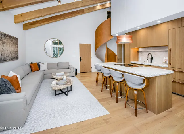 a living room with furniture and a mirror