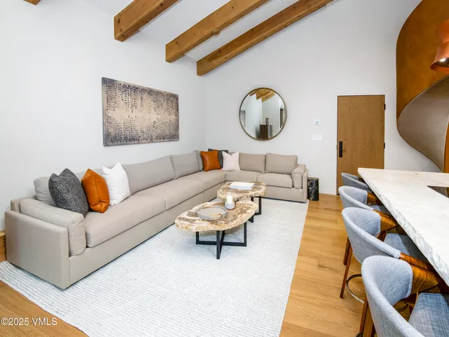 a dining room with furniture and a floor to ceiling window