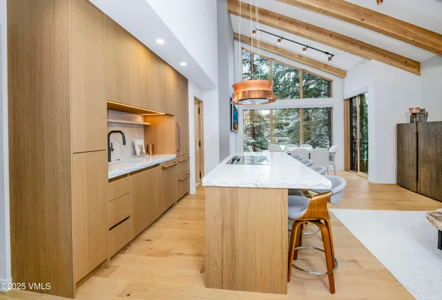 a view of a dining room with furniture large windows and wooden floor