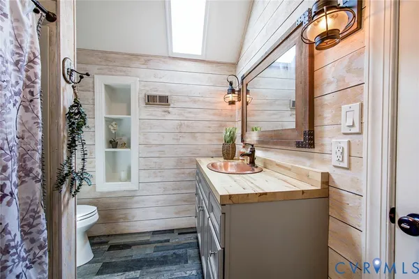 a bathroom with a shower curtain and a sink