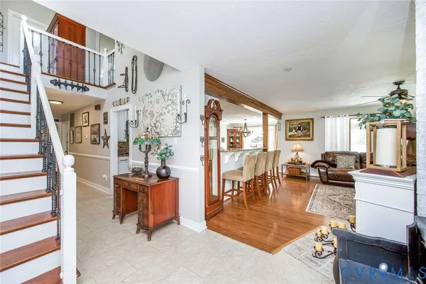 a living room with furniture a dining table and chairs with wooden floor