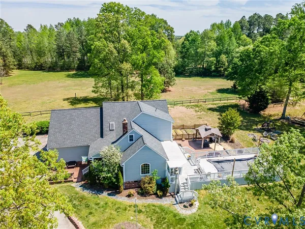 an aerial view of a house with a yard