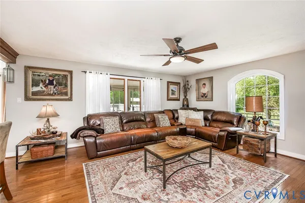 a living room with furniture a rug and a large window