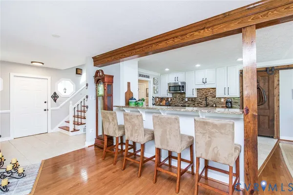 a kitchen with stainless steel appliances granite countertop a refrigerator and microwave