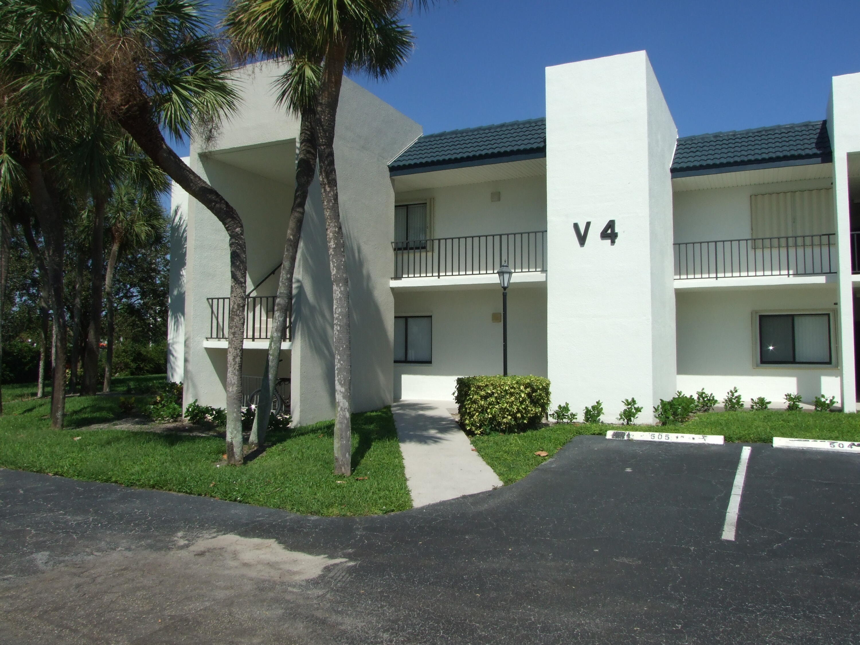 1605 Highway 1, Unit 203 V4 Jupiter, FL 33477 - Photo 1 of 33 a front view of a house with garden
