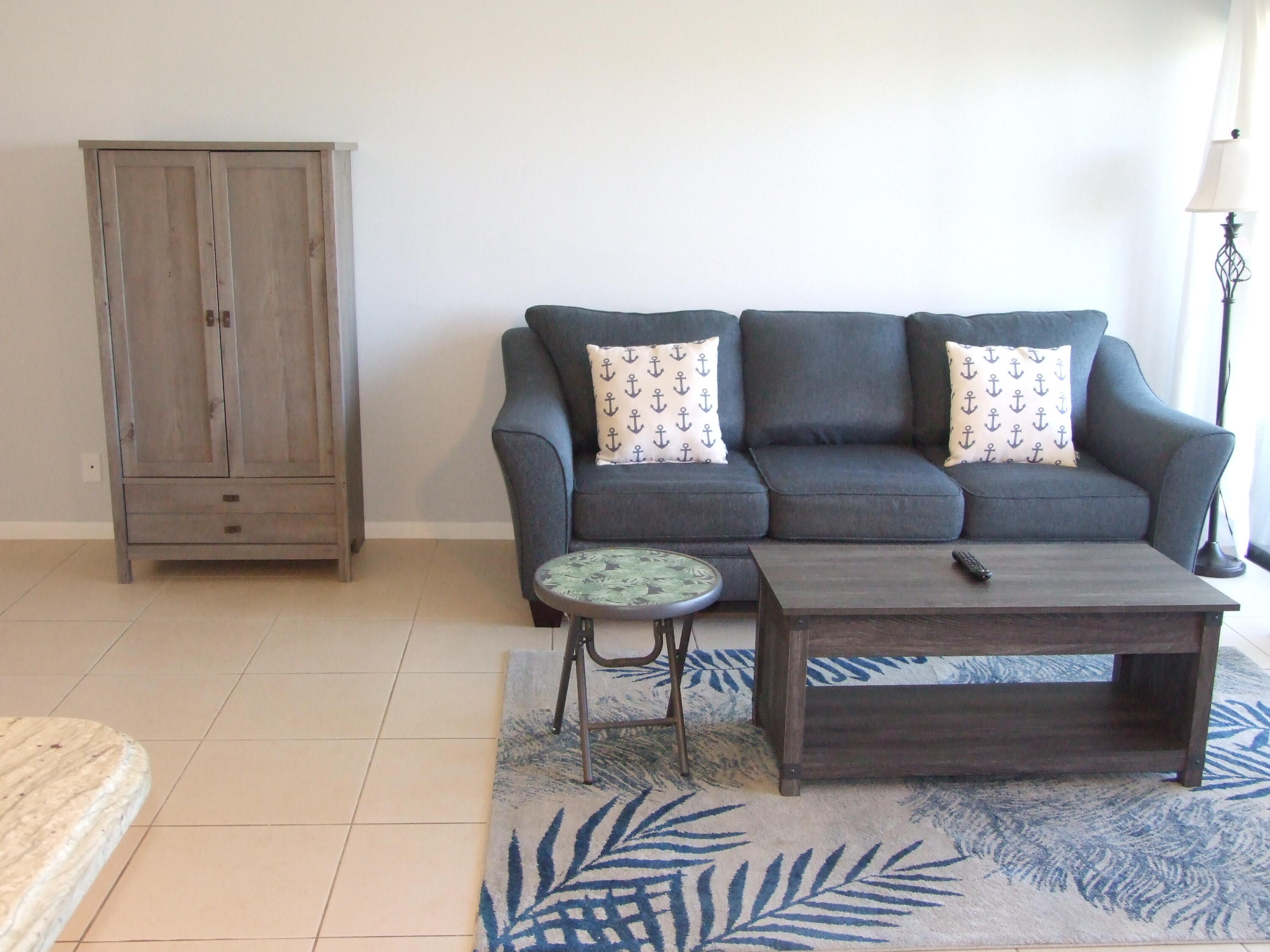 1605 Highway 1, Unit 203 V4 Jupiter, FL 33477 - Photo 12 of 33 a living room with furniture and a rug