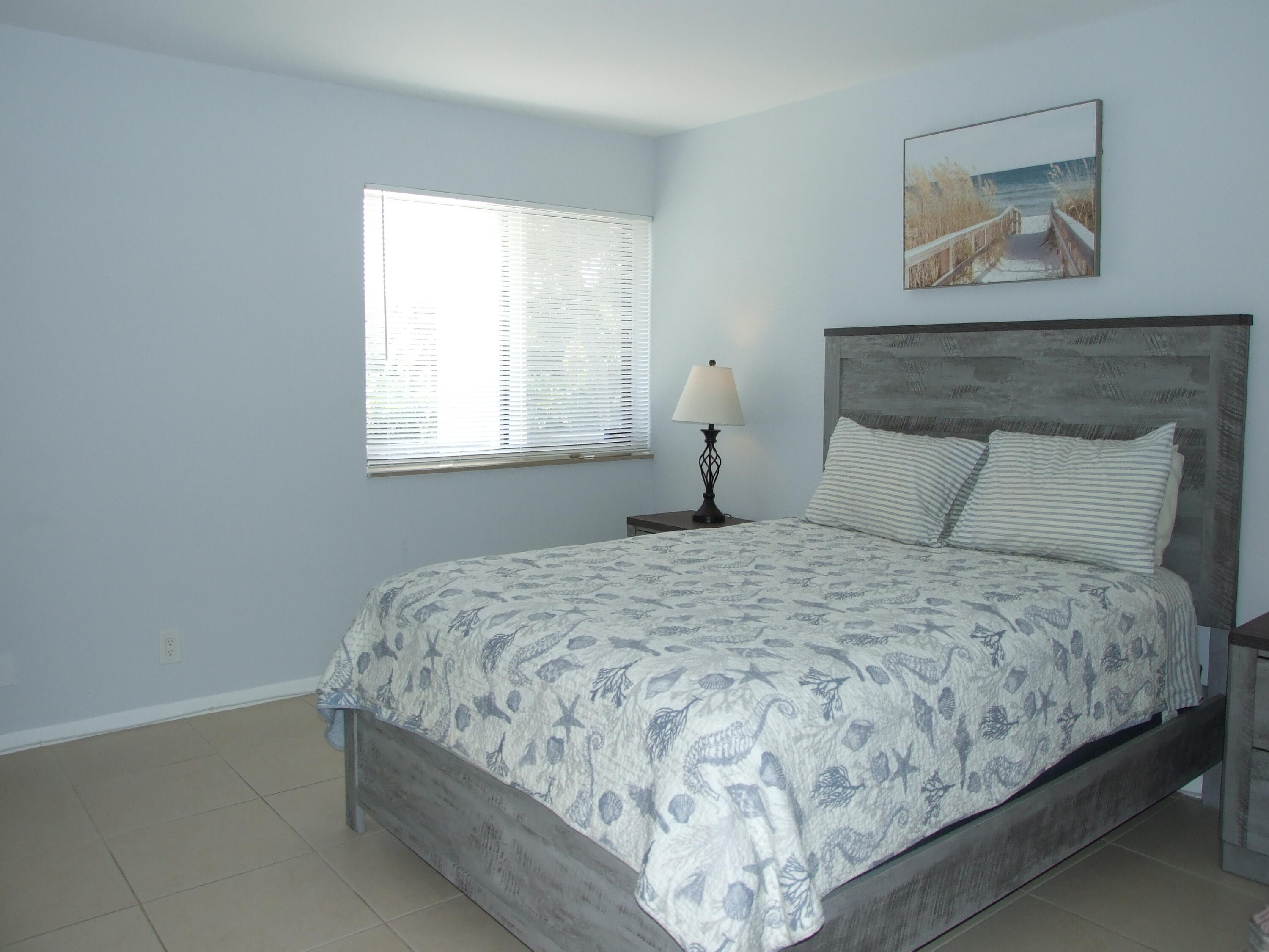 1605 Highway 1, Unit 203 V4 Jupiter, FL 33477 - Photo 20 of 33 a bedroom with bed and window