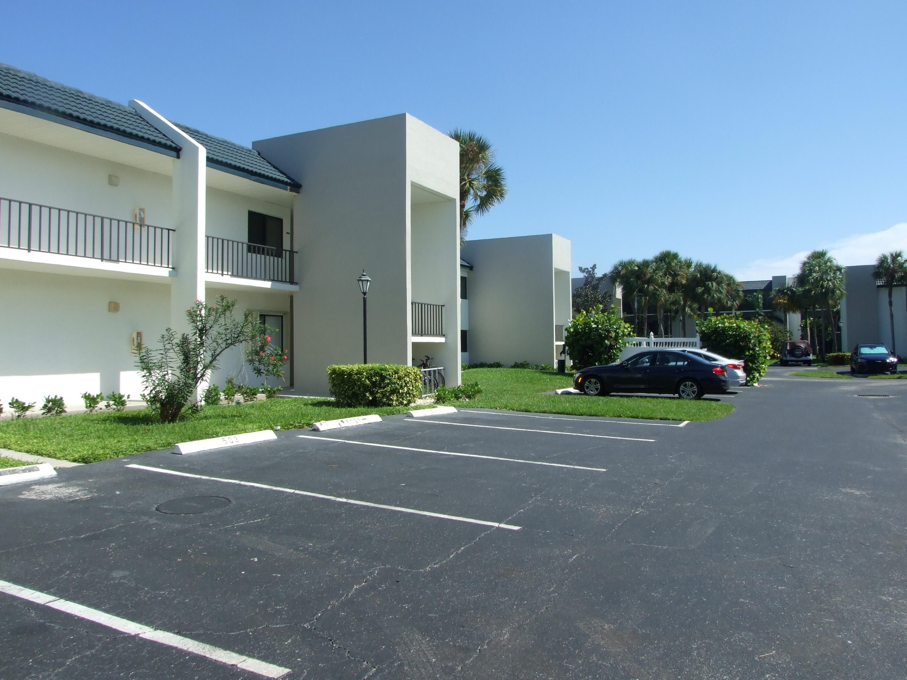 1605 Highway 1, Unit 203 V4 Jupiter, FL 33477 - Photo 2 of 33 a view of street with parked cars