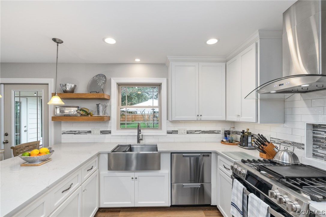 2730 West Brigstock Road Midlothian, VA 23113 - Photo 15 of 49 a kitchen with stainless steel appliances granite countertop a sink a stove a window cabinets and a counter top space