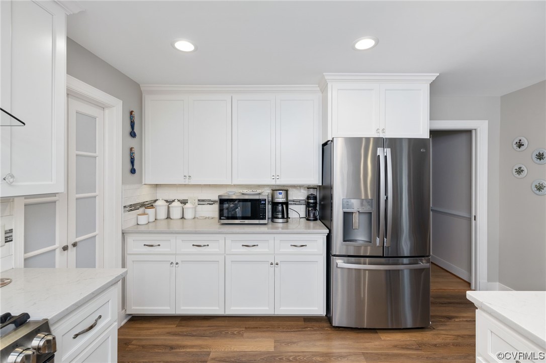 2730 West Brigstock Road Midlothian, VA 23113 - Photo 18 of 49 a kitchen with stainless steel appliances a refrigerator sink and cabinets