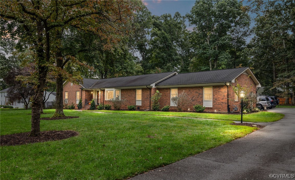 2730 West Brigstock Road Midlothian, VA 23113 - Photo 2 of 49 a front view of a house with a yard and trees