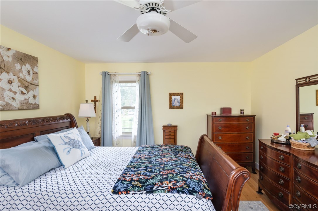 2730 West Brigstock Road Midlothian, VA 23113 - Photo 28 of 49 a bedroom with a bed and wooden floor